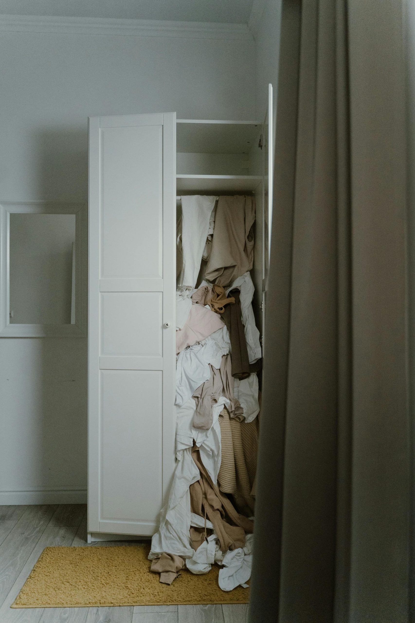 messy wardrobe overflowing clothes